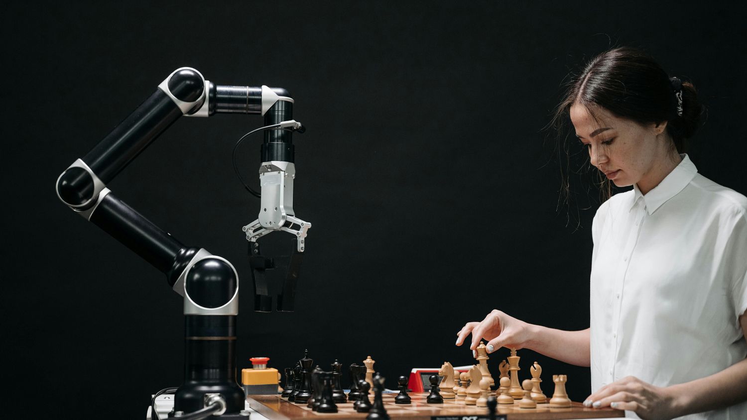 Woman playing chess against robot